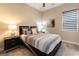 Serene bedroom with a comfortable queen-sized bed with a striped comforter and coordinated nightstands at 5436 Succulent Rose Dr, Las Vegas, NV 89135