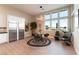 Open-concept dining area with large windows, modern lighting and stainless steel refrigerator at 5436 Succulent Rose Dr, Las Vegas, NV 89135