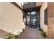 An inviting front door with a brick pathway lined with desert plants and a modern design at 5436 Succulent Rose Dr, Las Vegas, NV 89135