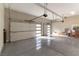 Spacious three-car garage with epoxy flooring and multiple doors providing convenient access at 5436 Succulent Rose Dr, Las Vegas, NV 89135