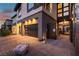 A well-lit three car garage with brick paved driveway and walkway leading to the front entrance of the house at 5436 Succulent Rose Dr, Las Vegas, NV 89135