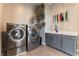 Well-equipped laundry room features modern washer and dryer set, ample counter space, and stylish decor at 5436 Succulent Rose Dr, Las Vegas, NV 89135