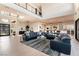 Spacious open-concept living room flowing into the kitchen, featuring a modern sectional and stylish decor at 5436 Succulent Rose Dr, Las Vegas, NV 89135