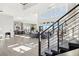 Staircase leading to the living room area with lots of natural light, light flooring, and access to the kitchen at 5436 Succulent Rose Dr, Las Vegas, NV 89135