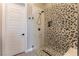 Stunning shower with decorative tile and a glass door, complemented by sleek, modern fixtures at 5436 Succulent Rose Dr, Las Vegas, NV 89135