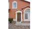 Brown door with stucco entryway and small bushes at 5459 Cactus Thorn Ave, Las Vegas, NV 89118