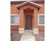 Brown door with a small entryway and stucco accents at 5459 Cactus Thorn Ave, Las Vegas, NV 89118