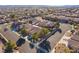 Overhead shot of homes in a desert neighborhood with street access at 551 Morning Mauve Ave, Las Vegas, NV 89183