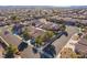 Aerial view of several homes in a neighborhood with desert landscaping and street views at 551 Morning Mauve Ave, Las Vegas, NV 89183