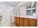 Bright bathroom boasts double sink vanity, shower with sliding glass doors, and modern lighting at 551 Morning Mauve Ave, Las Vegas, NV 89183