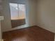 Simple bedroom with wood flooring and large window at 551 Morning Mauve Ave, Las Vegas, NV 89183