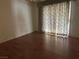 Bedroom with wood floors and sliding glass doors with curtains at 551 Morning Mauve Ave, Las Vegas, NV 89183