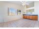 Bright dining area with modern ceiling fan, tile floors, and natural light at 551 Morning Mauve Ave, Las Vegas, NV 89183