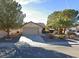 Single-story home with a two-car garage and desert landscaping at 551 Morning Mauve Ave, Las Vegas, NV 89183