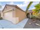 Exterior view of a home with a two-car garage, desert landscaping, and a covered front entrance at 551 Morning Mauve Ave, Las Vegas, NV 89183