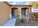 Charming front porch featuring arched entryways, a tiled walkway, and low-maintenance desert landscaping at 551 Morning Mauve Ave, Las Vegas, NV 89183