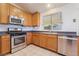 Charming kitchen featuring stainless steel appliances and wooden cabinetry at 551 Morning Mauve Ave, Las Vegas, NV 89183