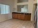 Kitchen features a breakfast bar and dark wood cabinets at 551 Morning Mauve Ave, Las Vegas, NV 89183