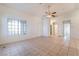 Open-concept living area with tile floors, a ceiling fan, and easy access to other rooms in the home at 551 Morning Mauve Ave, Las Vegas, NV 89183