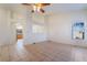 Spacious living room with tile flooring, a ceiling fan, and large windows for ample natural light at 551 Morning Mauve Ave, Las Vegas, NV 89183