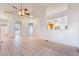 Spacious living room with neutral tile flooring and ceiling fan at 551 Morning Mauve Ave, Las Vegas, NV 89183