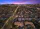 Dusk aerial showcases the city skyline and the manicured neighborhood at 5555 W Desert Inn Rd, Las Vegas, NV 89146