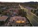 A bird's eye view of the property highlighting its tile roof, landscaping, and location near a main road at 5555 W Desert Inn Rd, Las Vegas, NV 89146