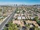 Stunning aerial view showcasing the neighborhood homes and the skyline at 5555 W Desert Inn Rd, Las Vegas, NV 89146