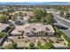 Aerial view of a home with a tile roof with desert landscaping and lush green hedges at 5555 W Desert Inn Rd, Las Vegas, NV 89146