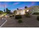 Backyard featuring desert landscaping with mature trees and bushes, and lighting at 5555 W Desert Inn Rd, Las Vegas, NV 89146