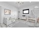 Bright Bedroom with a daybed, a crib, a dark trimmed window, and a modern chandelier at 5555 W Desert Inn Rd, Las Vegas, NV 89146