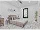 Cozy bedroom with a modern bed, floating shelves, and natural light from the window at 5555 W Desert Inn Rd, Las Vegas, NV 89146