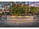 Entrance sign to West Desert Inn Estates, framed by mature trees and manicured landscaping at 5555 W Desert Inn Rd, Las Vegas, NV 89146