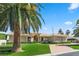 Lovely single-story home with well-manicured lawn, palm trees and desert landscaping at 5555 W Desert Inn Rd, Las Vegas, NV 89146