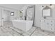 Main bathroom featuring large mirrors, a standing soaking tub, and sleek vanity lighting at 5555 W Desert Inn Rd, Las Vegas, NV 89146