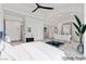 Bright main bedroom featuring high ceilings, a ceiling fan, and an adjacent bathroom with a soaking tub at 5555 W Desert Inn Rd, Las Vegas, NV 89146