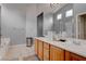 Elegant bathroom with double vanity, soaking tub, and large mirror at 5600 Nimes Ave, Las Vegas, NV 89141