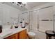 Clean bathroom with a shower/tub combo and wood cabinets at 5600 Nimes Ave, Las Vegas, NV 89141