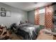 Cozy bedroom with a gray bedspread and patterned curtains at 5600 Nimes Ave, Las Vegas, NV 89141