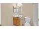 Clean bathroom with wood vanity, toilet and shower/tub combo at 5725 Copper Sun Ct, North Las Vegas, NV 89031