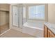 Main bathroom with a shower, tub, and wood cabinets at 5725 Copper Sun Ct, North Las Vegas, NV 89031