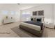 Virtually staged main bedroom with a gray platform bed and neutral decor at 5725 Copper Sun Ct, North Las Vegas, NV 89031