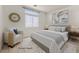 Virtually staged bedroom with king-size bed and sitting area at 5725 Copper Sun Ct, North Las Vegas, NV 89031