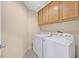 Laundry room with washer, dryer and wood cabinets at 5725 Copper Sun Ct, North Las Vegas, NV 89031