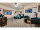 Bright bedroom featuring a green velvet bed and accent chairs at 5895 S Gateway Rd, Las Vegas, NV 89120