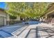 Landscaped courtyard with a large tree and spacious concrete at 5895 S Gateway Rd, Las Vegas, NV 89120