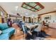 Large dining room with a long table, unique chairs, and a cowhide rug at 5895 S Gateway Rd, Las Vegas, NV 89120