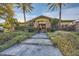 Elegant home with stone accents and landscaped entryway at 5895 S Gateway Rd, Las Vegas, NV 89120