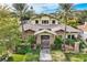 Stunning two-story home with a tile roof, gated entry, and lush landscaping at 5895 S Gateway Rd, Las Vegas, NV 89120