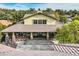 Back view of the home, showcasing the large covered patio and landscaping at 5895 S Gateway Rd, Las Vegas, NV 89120